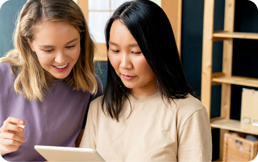 Two women collaborating on a digital device